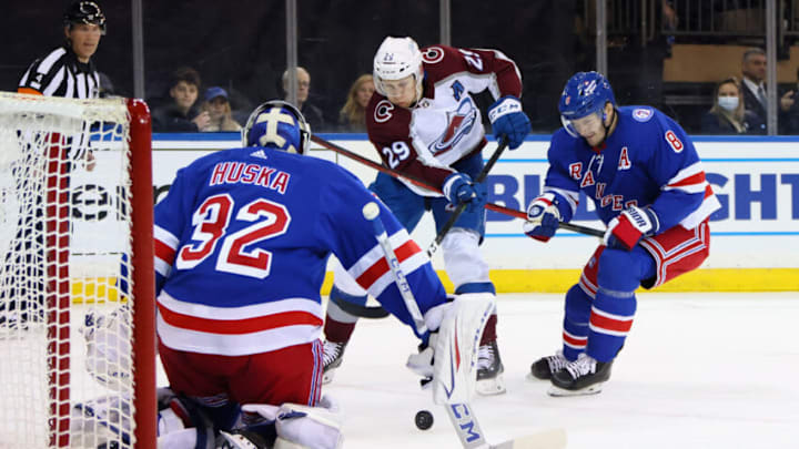 NEW YORK, NEW YORK - DECEMBER 08: Jacob Trouba #8 and Adam Huska #32 of the New York Rangers defend against Nathan MacKinnon #29 of the Colorado Avalanche during the first period at Madison Square Garden on December 08, 2021 in New York City. (Photo by Bruce Bennett/Getty Images)
