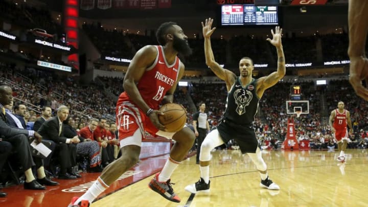 HOUSTON, TX - JANUARY 09: James Harden #13 of the Houston Rockets steps back for a three point shot defended by George Hill #3 of the Milwaukee Bucks in the second half at Toyota Center on January 9, 2019 in Houston, Texas. NOTE TO USER: User expressly acknowledges and agrees that, by downloading and or using this photograph, User is consenting to the terms and conditions of the Getty Images License Agreement. (Photo by Tim Warner/Getty Images)