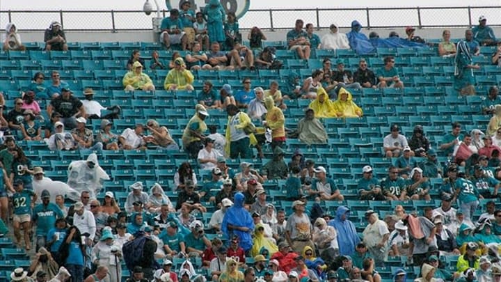 Sept. 16, 2012; Jacksonville FL, USA; Jacksonville Jaguars fans try to stay dry in the rain during the second quarter of their game against the Houston Texans at EverBank Field. The Texans won 27-7. Mandatory Credit: Phil Sears-USA TODAY Sports