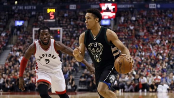 Apr 15, 2017; Toronto, Ontario, CAN; Milwaukee Bucks guard Malcolm Brogdon (13) dribbles past Toronto Raptors forward DeMarre Carroll (5) in game one of the first round of the 2017 NBA Playoffs at Air Canada Centre. Milwaukee defeated Toronto 97-83. Mandatory Credit: John E. Sokolowski-USA TODAY Sports