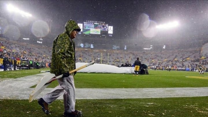 Dec 9, 2012; Green Bay, WI, USA; Workers remove snow from the field before the game between the Green Bay Packers and Detroit Lions at Lambeau Field. Mandatory Credit: Benny Sieu-USA TODAY Sports