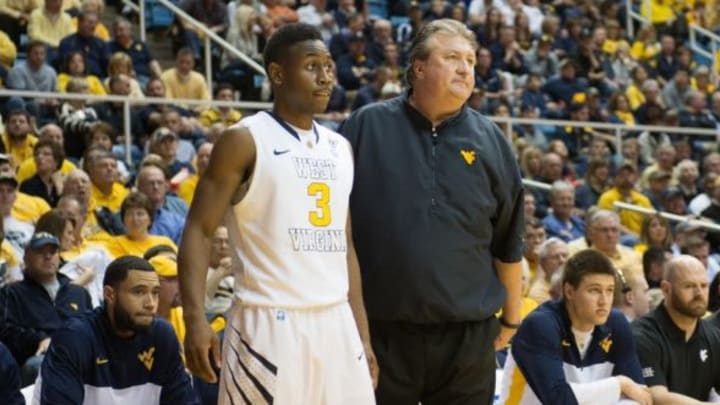 Jan 11, 2014; Morgantown, WV, USA; West Virginia Mountaineers guard Juwan Staten (3) stands with head coach Bob Huggins during a break in play during the second half at WVU Coliseum. Oklahoma State Cowboys defeated West Virginia Mountaineers 73-72. Mandatory Credit: Tommy Gilligan-USA TODAY Sports