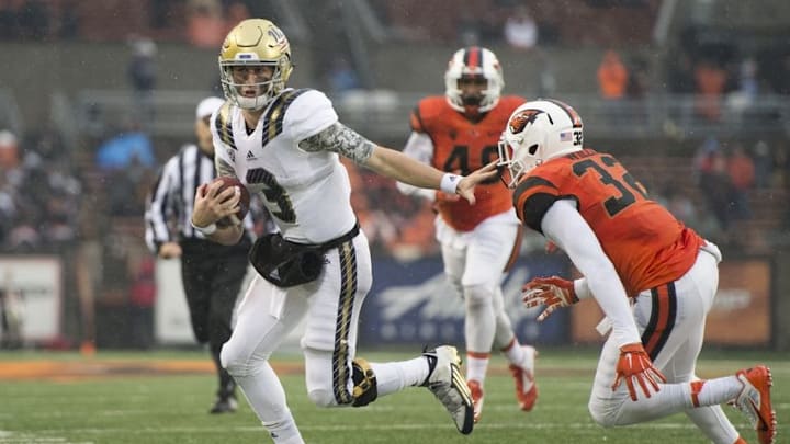 Nov 7, 2015; Corvallis, OR, USA; UCLA quarterback Josh Rosen (3) picks up a first down as he runs past Oregon State linebacker Jonathan Willis (32) during the second half at Reser Stadium. UCLA won 41-0. Mandatory Credit: Troy Wayrynen-USA TODAY Sports