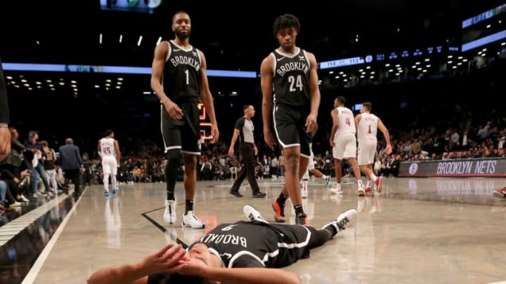 Oct 25, 2023; Brooklyn, New York, USA; Brooklyn Nets forward Mikal Bridges (1) and guard Cam Thomas (24) walk towards forward Cameron Johnson (2) as he reacts after missing his shot at the buzzer during the fourth quarter against the Cleveland Cavaliers at Barclays Center. Mandatory Credit: Brad Penner-USA TODAY Sports