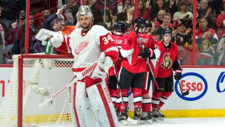 Feb 20, 2016; Ottawa, Ontario, CAN; The Ottawa Senators celebrate a goal scored by center Zach Smith (15) against Detroit Red Wings goalie Petr Mrazek (34) in the second period at the Canadian Tire Centre. Mandatory Credit: Marc DesRosiers-USA TODAY Sports