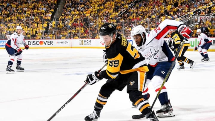 PITTSBURGH, PA - MAY 07: Jake Guentzel #59 of the Pittsburgh Penguins handles the puck against Devante Smith-Pelly #25 of the Washington Capitals in Game Six of the Eastern Conference Second Round during the 2018 NHL Stanley Cup Playoffs at PPG Paints Arena on May 7, 2018 in Pittsburgh, Pennsylvania. (Photo by Joe Sargent/NHLI via Getty Images)