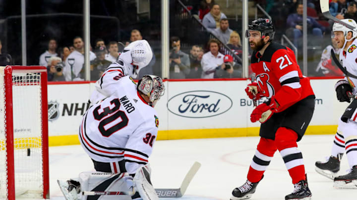 NEWARK, NJ - JANUARY 14: New Jersey Devils right wing Kyle Palmieri (21) shoots and scores past Chicago Blackhawks goaltender Cam Ward (30) during the second period of the National Hockey League game between the New Jersey Devils and the Chicago Blackhawks on January 14, 2019, at the Prudential Center in Newark, NJ. (Photo by Rich Graessle/Icon Sportswire via Getty Images)