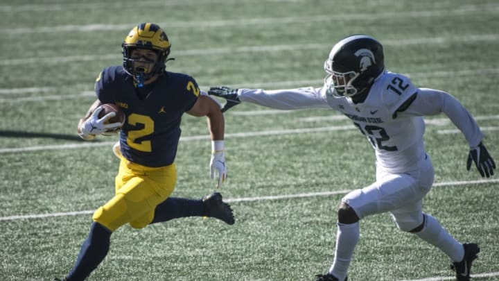 ANN ARBOR, MI - OCTOBER 31: Chris Jackson #12 of the Michigan State Spartans misses a tackle against Blake Corum #2 of the Michigan Wolverines, which resulted in a touchdown, during the first quarter at Michigan Stadium on October 31, 2020 in Ann Arbor, Michigan. (Photo by Nic Antaya/Getty Images)