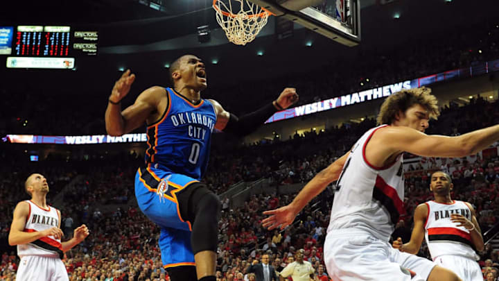 PORTLAND, OR - OCTOBER 29: Russell Westbrook #0 of the Oklahoma City Thunder dunks the ball on Robin Lopez #42 of the Portland Trail Blazers at the end of the second quarter of the game at Moda Center on October 29, 2014 in Portland, Oregon. NOTE TO USER: User expressly ackowledges and agrees that by downloading and/or using this photograph, user is consenting to the terms and conditions of the Getty Images License Agreement. (Photo by Steve Dykes/Getty Images)