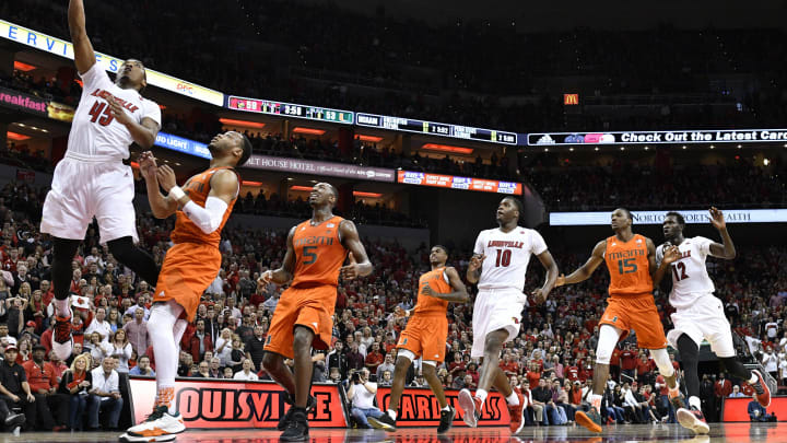Feb 11, 2017; Louisville, KY, USA; Louisville Cardinals guard Donovan Mitchell (45) shoots against Miami (Fl) Hurricanes guard Bruce Brown (11) during the second half at KFC Yum! Center. Louisville defeated Miami 71-66. Mandatory Credit: Jamie Rhodes-USA TODAY Sports