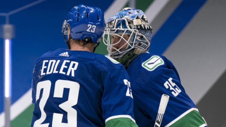 VANCOUVER, BC - MARCH 04: Goalie Thatcher Demko of the Vancouver Canucks is congratulated by teammate Alex Edler #23 after a 3-1 win over the Toronto Maple Leafs at Rogers Arena on March 4, 2021 in Vancouver, Canada. (Photo by Rich Lam/Getty Images)