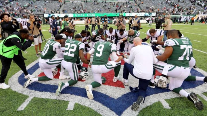 EAST RUTHERFORD, NJ - OCTOBER 15: Members of the New England Patriots and New York Jets (Photo by Abbie Parr/Getty Images)