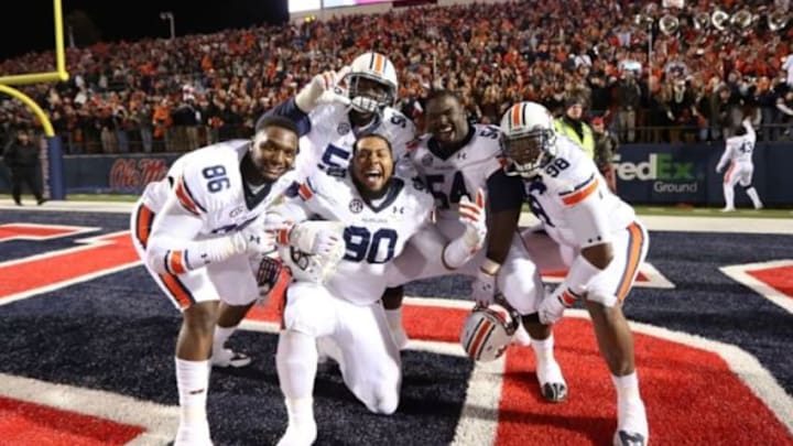 Nov 1, 2014; Oxford, MS, USA; Auburn Tigers defensive lineman DaVonte Lambert (86) Ben Bradley (50) Gabe Wright (90) Jeffrey Whitaker (54) and Angelo Blackson (98) celebrate at the conclusion of the game against the Ole Miss Rebels at Vaught-Hemingway Stadium. Auburn defeated Ole Miss 35-31. Mandatory Credit: Nelson Chenault-USA TODAY Sports Nov 1, 2014; Oxford, MS, USA; Auburn Tigers defensive lineman DaVonte Lambert (86) Ben Bradley (50) Gabe Wright (90) Jeffrey Whitaker (54) and Angelo Blackson (98) celebrate at the conclusion of the game against the Ole Miss Rebels at Vaught-Hemingway Stadium. Auburn defeated Ole Miss 35-31. Mandatory Credit: Nelson Chenault-USA TODAY Sports