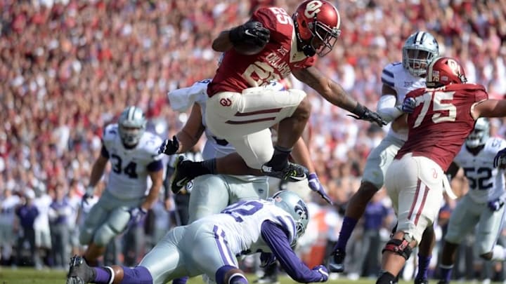 Oct 15, 2016; Norman, OK, USA; Oklahoma Sooners running back Joe Mixon (25) hurdles Kansas State Wildcats defensive back Dante Barnett (22) to score a touchdown during the first quarter at Gaylord Family - Oklahoma Memorial Stadium. Mandatory Credit: Mark D. Smith-USA TODAY Sports