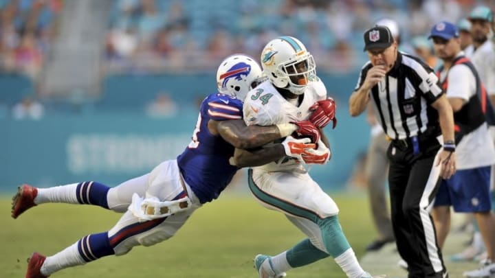 Sep 27, 2015; Miami Gardens, FL, USA; Buffalo Bills outside linebacker Nigel Bradham (53) tackles Miami Dolphins running back Damien Williams (34) during the second half at Sun Life Stadium. Mandatory Credit: Steve Mitchell-USA TODAY Sports