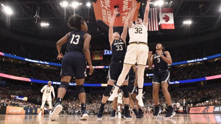 TAMPA, FL - APRIL 05: Jessica Shepard #32 of the Notre Dame Fighting Irish shoots between Katie Lou Samuelson #33 and Megan Walker #3 of the Connecticut Huskies at Amalie Arena on April 5, 2019 in Tampa, Florida. (Photo by Ben Solomon/NCAA Photos via Getty Images)