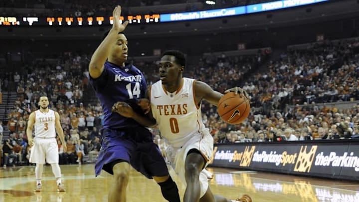 Mar 7, 2015; Austin, TX, USA; Texas Longhorns guard Kendal Yancy (0) drives against Kansas State Wildcats guard Justin Edwards (14) during the first half at the Frank Erwin Special Events Center. Mandatory Credit: Brendan Maloney-USA TODAY Sports Mar 7, 2015; Austin, TX, USA; Texas Longhorns guard Kendal Yancy (0) drives against Kansas State Wildcats guard Justin Edwards (14) during the first half at the Frank Erwin Special Events Center. Mandatory Credit: Brendan Maloney-USA TODAY Sports