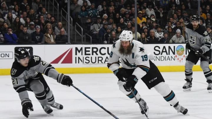 Dec 31, 2016; Los Angeles, CA, USA; San Jose Sharks center Joe Thornton (19) handles the puck as Los Angeles Kings center Nick Shore (21) defends in the third period during a NHL hockey match at Staples Center. The Kings defeated the Sharks 3-2. Mandatory Credit: Kirby Lee-USA TODAY Sports