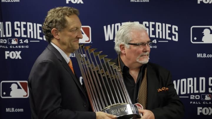 Oct 29, 2014; Kansas City, MO, USA; San Francisco Giants general manager Brian Sabean (right) and chief executive officer Larry Baer hold the Commissioners Trophy after game seven of the 2014 World Series against the Kansas City Royals at Kauffman Stadium. Mandatory Credit: Charlie Neibergall/Pool Photo via USA TODAY Sports