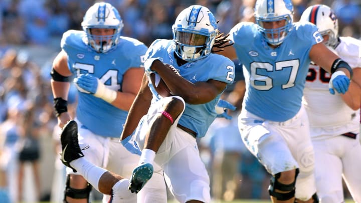 CHAPEL HILL, NC – OCTOBER 14: Andrew Brown #9 of the Virginia Cavaliers tackled Jordon Brown #2 of the North Carolina Tar Heels during their game at Kenan Stadium on October 14, 2017 in Chapel Hill, North Carolina. (Photo by Grant Halverson/Getty Images)