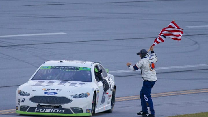 TALLADEGA, AL - OCTOBER 15: A crewman brings Brad Keselowski, Team Penske, Miller Lite Ford Fusion an American Flag after winning the Alabama 500 Monster Energy Cup Series race on October 15, 2017 at the Talladega Superspeedway in Talladega, AL. (Photo by David John Griffin/Icon Sportswire via Getty Images)
