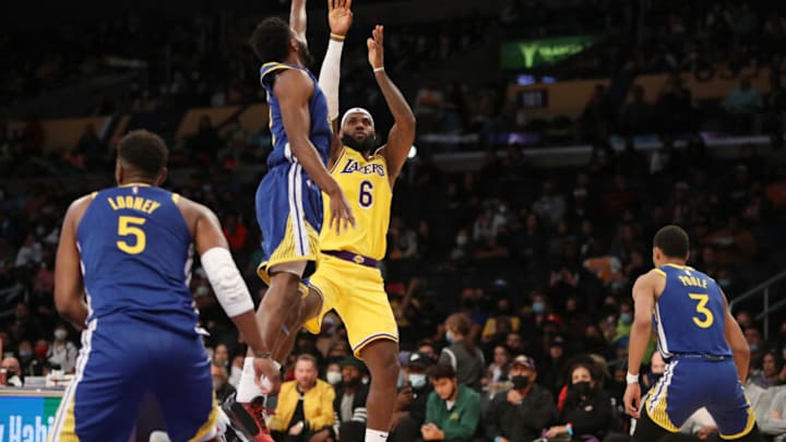 Oct 12, 2021; Los Angeles, California, USA; Los Angeles Lakers forward LeBron James (6) shoots the ball against Golden State Warriors forward Andrew Wiggins (22) during the third quarter at Staples Center. The Warriors won 111-99. Mandatory Credit: Kiyoshi Mio-USA TODAY Sports