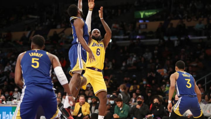 Oct 12, 2021; Los Angeles, California, USA; Los Angeles Lakers forward LeBron James (6) shoots the ball against Golden State Warriors forward Andrew Wiggins (22) during the third quarter at Staples Center. The Warriors won 111-99. Mandatory Credit: Kiyoshi Mio-USA TODAY Sports