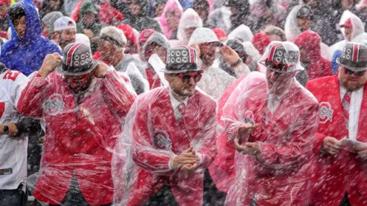 Nov 5, 2022; Evanston, Illinois, USA; Ohio State Buckeyes fans stand in the blowing rain during the first half of the NCAA football game against the Northwestern Wildcats at Ryan Field. Mandatory Credit: Adam Cairns-The Columbus DispatchNcaa Football Ohio State Buckeyes At Northwestern Wildcats
