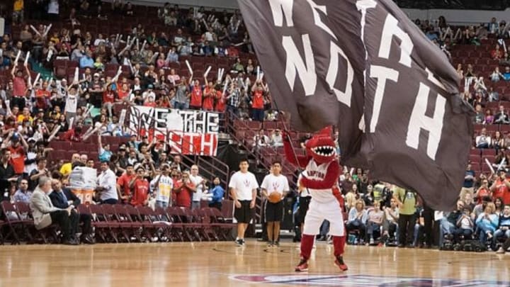 Oct 5, 2014; Vancouver, British Columbia, CAN; The Toronto Raptors mascot greats fans before the start of the first half against the Sacramento Kings at Rogers Arena. The Toronto Raptors won 99-94. Mandatory Credit: Anne-Marie Sorvin-USA TODAY Sports