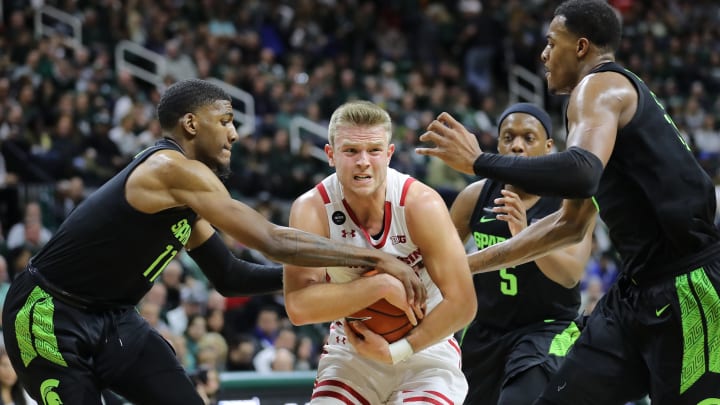 EAST LANSING, MI – JANUARY 17: Brad Davison #34 of the Wisconsin Badgers drives to the basket and draws a foul from Aaron Henry #11 of the Michigan State Spartans at the Breslin Center on January 17, 2020 in East Lansing, Michigan. (Photo by Rey Del Rio/Getty Images)