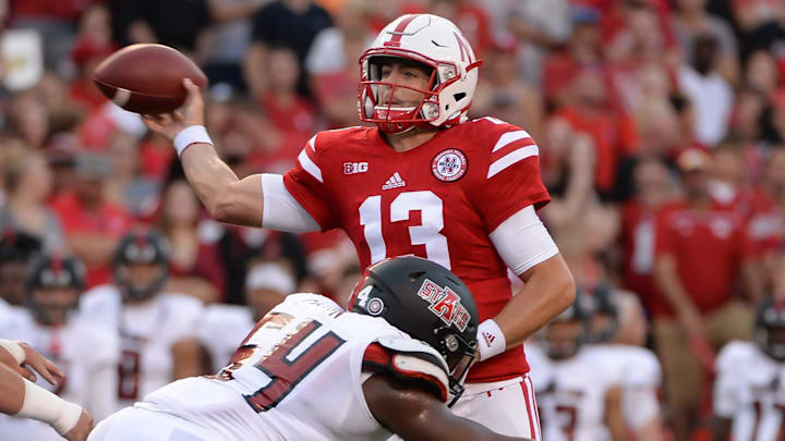 LINCOLN, NE – SEPTEMBER 02: Quarterback Tanner Lee #13 of the Nebraska Cornhuskers attempts a pass ahead of the rush from defensive end Caleb Caston #54 of the Arkansas State Red Wolves at Memorial Stadium on September 2, 2017 in Lincoln, Nebraska. (Photo by Steven Branscombe/Getty Images)