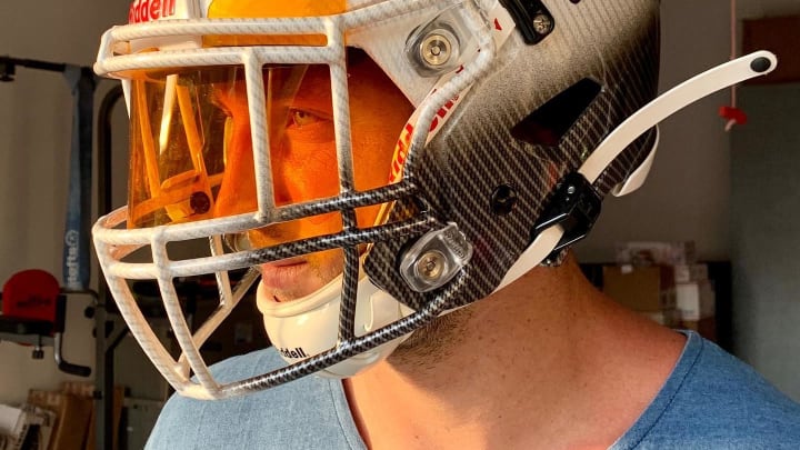 Tim Tebow takes a photo with a Denver Broncos alternate helmet. Tim Tebow takes a photo with a Denver Broncos alternate helmet.