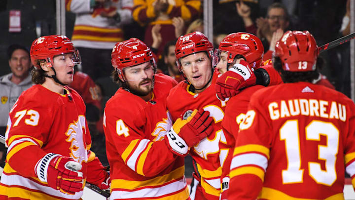 CALGARY, AB - FEBRUARY 26: Matthew Tkachuk #19 (C) of the Calgary Flames celebrates with his teammates after scoring against the Minnesota Wild during an NHL game at Scotiabank Saddledome on February 26, 2022 in Calgary, Alberta, Canada. (Photo by Derek Leung/Getty Images)