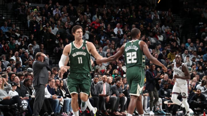 BROOKLYN, NY - JANUARY 18: Brook Lopez #11, and Khris Middleton #22 of the Milwaukee Bucks hi-five each other during the game against the Brooklyn Nets on January 18, 2020 at Barclays Center in Brooklyn, New York. NOTE TO USER: User expressly acknowledges and agrees that, by downloading and or using this Photograph, user is consenting to the terms and conditions of the Getty Images License Agreement. Mandatory Copyright Notice: Copyright 2020 NBAE (Photo by Nathaniel S. Butler/NBAE via Getty Images)