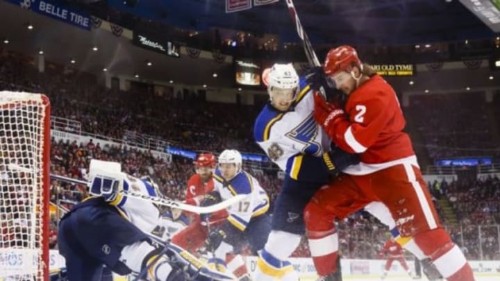 Mar 22, 2015; Detroit, MI, USA; St. Louis Blues goalie Jake Allen (34) makes a save as defenseman Petteri Lindbohm (48) and Detroit Red Wings defenseman Brendan Smith (2) fight for position with in the first period at Joe Louis Arena. Mandatory Credit: Rick Osentoski-USA TODAY Sports