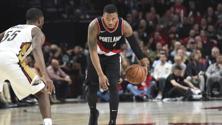 PORTLAND, OR - OCTOBER 24: Damian Lillard #0 of the Portland Trail Blazers looks to get past E'Twaun Moore #55 of the New Orleans Pelicans drives to the basket during the fourth quarter of the game at Moda Center on October 24, 2017 in Portland, Oregon. The Blazers won the game 103-93. (Photo by Steve Dykes/Getty Images)