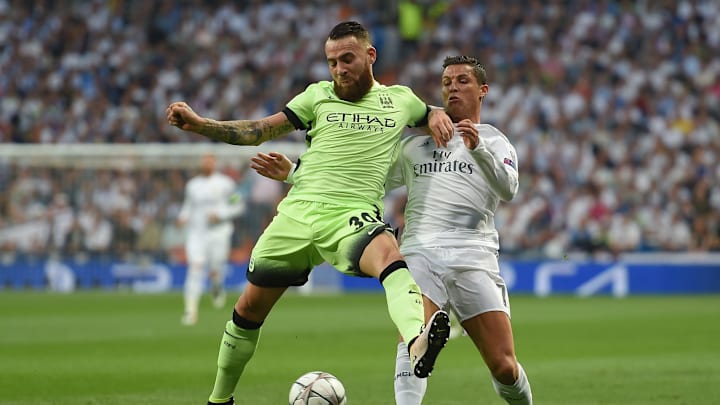 MADRID, ENGLAND - MAY 04: Nicolas Otamendi of Manchester City holds off the challenge from Cristiano Ronaldo of Real Madrid during the UEFA Champions League semi final, second leg match between Real Madrid and Manchester City FC at Estadio Santiago Bernabeu on May 4, 2016 in Madrid, Spain. (Photo by Michael Regan/Getty Images)