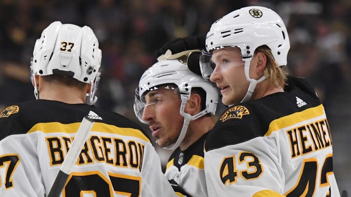 LAS VEGAS, NEVADA - OCTOBER 08: Patrice Bergeron #37, Brad Marchand #63 and Danton Heinen #43 of the Boston Bruins celebrate after Marchand scored a first-period power-play goal against the Vegas Golden Knights during their game at T-Mobile Arena on October 8, 2019 in Las Vegas, Nevada. (Photo by Ethan Miller/Getty Images)