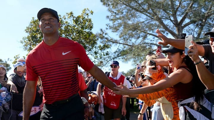 SAN DIEGO, CA - JANUARY 28: Tiger Woods high fives a fan during the final round of the Farmers Insurance Open at Torrey Pines South on January 28, 2018 in San Diego, California. (Photo by Donald Miralle/Getty Images)