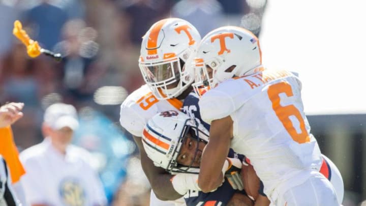 AUBURN, AL - OCTOBER 13: Linebacker Darrell Taylor #19 of the Tennessee Volunteers and defensive back Alontae Taylor #6 of the Tennessee Volunteers tackle running back Malik Miller #32 of the Auburn Tigers during the third quarter at Jordan-Hare Stadium on October 13, 2018 in Auburn, Alabama. (Photo by Michael Chang/Getty Images)