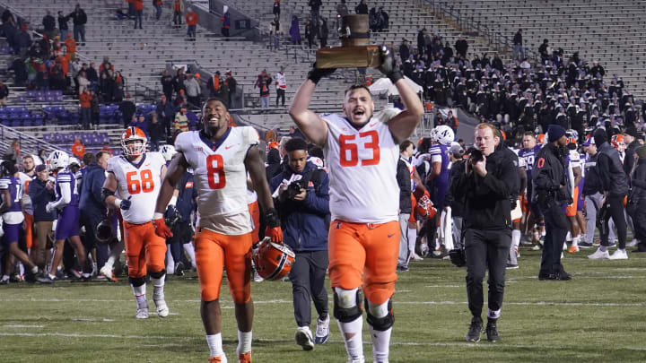 Nov 26, 2022; Evanston, Illinois, USA; Illinois Fighting Illini offensive lineman Alex Palczewski (63) carries The Land of Lincoln Trophy after Illinois defeated the Northwestern Wildcats at Ryan Field. Mandatory Credit: David Banks-USA TODAY Sports