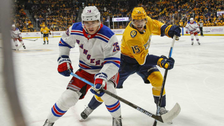 NASHVILLE, TENNESSEE - NOVEMBER 02:Libor Hajek #25 of the New York Rangers and Craig Smith #15 of the Nashville Predators chase a puck into the corner during the first period at Bridgestone Arena on November 02, 2019 in Nashville, Tennessee. (Photo by Frederick Breedon/Getty Images)