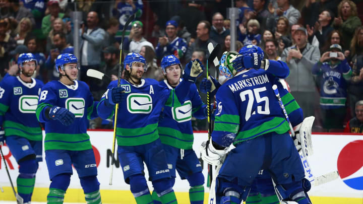 Jacob Markstrom of the Vancouver Canucks is congratulated by the team. (Photo by Jeff Vinnick/NHLI via Getty Images)