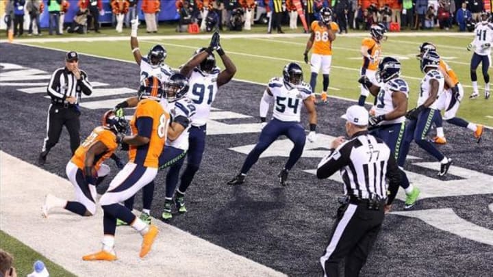 Feb 2, 2014; East Rutherford, NJ, USA; Denver Broncos running back Knowshon Moreno (27) recovers the ball in the end zone for a safety in Super Bowl XLVIII against the Seattle Seahawks in the first quarter at MetLife Stadium. Mandatory Credit: Joe Camporeale-USA TODAY Sports
