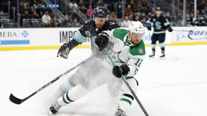 SEATTLE, WASHINGTON - APRIL 03: Adam Larsson #6 of the Seattle Kraken defends Radek Faksa #12 of the Dallas Stars during the first period at Climate Pledge Arena on April 03, 2022 in Seattle, Washington. (Photo by Steph Chambers/Getty Images)