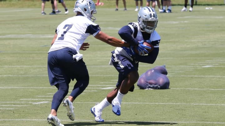 May 6, 2016; Irving, TX, USA; Dallas Cowboys number one draft pick Ezekiel Elliott (21) takes a hand off from quarterback Jameill Showers (7) during rookie minicamp at Dallas Cowboys headquarters at Valley Ranch. Mandatory Credit: Matthew Emmons-USA TODAY Sports