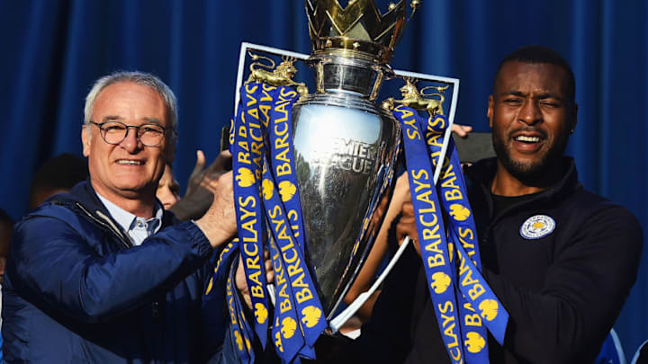LEICESTER, ENGLAND - MAY 16: (L-R) Claudio Ranieri Manager of Leicester City and captain Wes Morgan of Leicester City show the trophy to the fans during the Leicester City Barclays Premier League winners bus parade on May 16, 2016 in Leicester, England. (Photo by Laurence Griffiths/Getty Images)