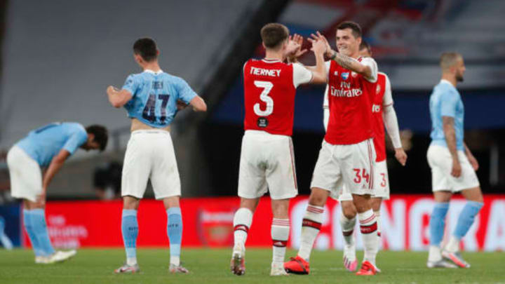 LONDON, ENGLAND – JULY 18: Kieran Tierney and Granit Xhaka of Arsenal celebrate following the FA Cup Semi Final match between Arsenal and Manchester City at Wembley Stadium on July 18, 2020 in London, England. Football Stadiums around Europe remain empty due to the Coronavirus Pandemic as Government social distancing laws prohibit fans inside venues resulting in all fixtures being played behind closed doors. (Photo by Matthew Childs/Pool via Getty Images)