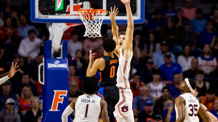 Feb 19, 2022; Gainesville, Florida, USA; Florida Gators guard Myreon Jones (0) shoots over Auburn Tigers forward Walker Kessler (13) during the first half at Billy Donovan Court at Exactech Arena. Mandatory Credit: Matt Pendleton-USA TODAY Sports