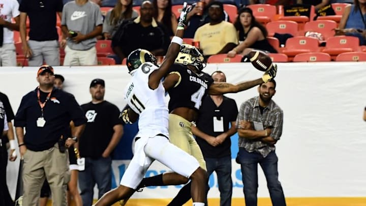 Sep 2, 2016; Denver, CO, USA; Colorado Buffaloes wide receiver Bryce Bobo (4) pulls in a reception over Colorado State Rams defensive back Jordon Vaden (11) in the second quarter at Sports Authority Field. Mandatory Credit: Ron Chenoy-USA TODAY Sports